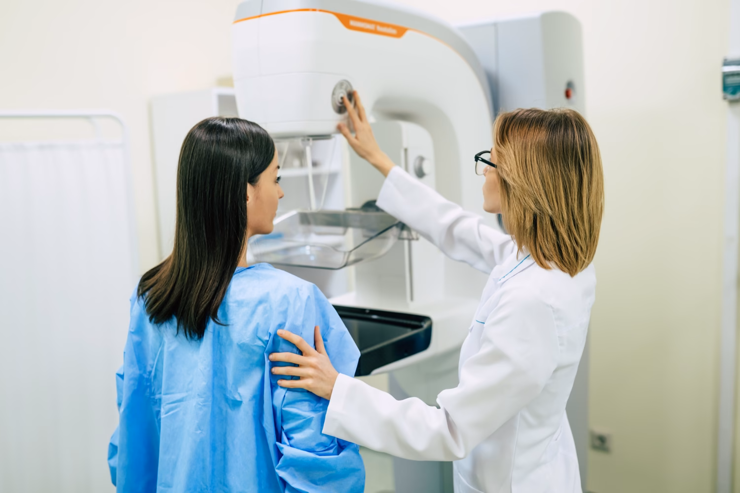 Patient getting ready for breast MRI scan with doctor support