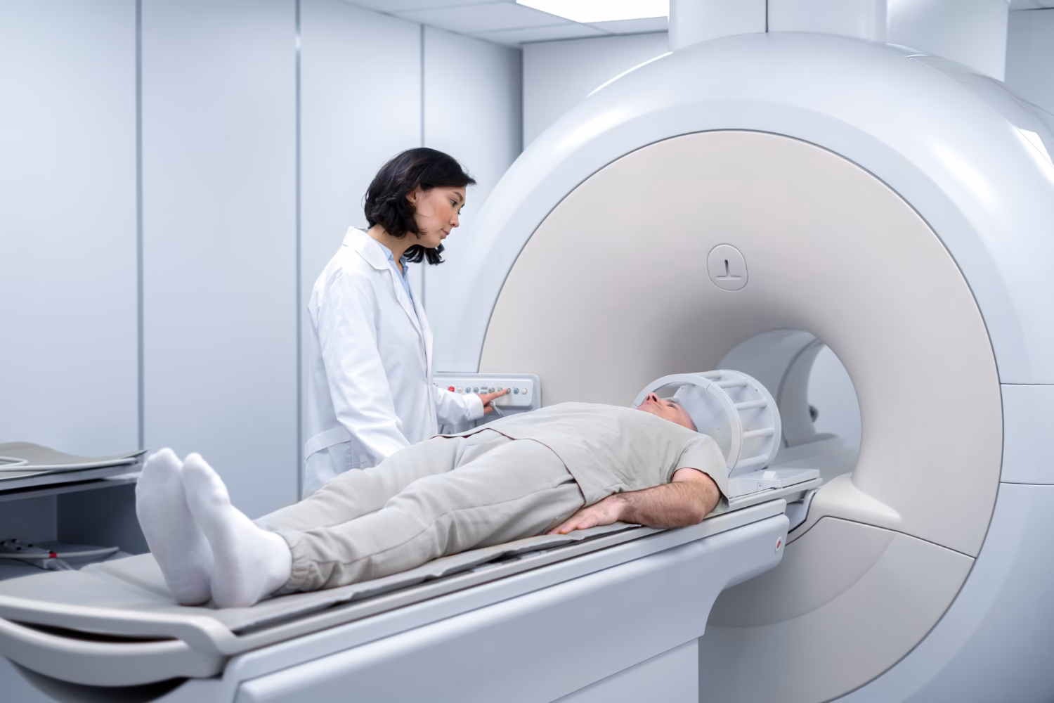 Doctor performing neck MRI scan procedure in hospital