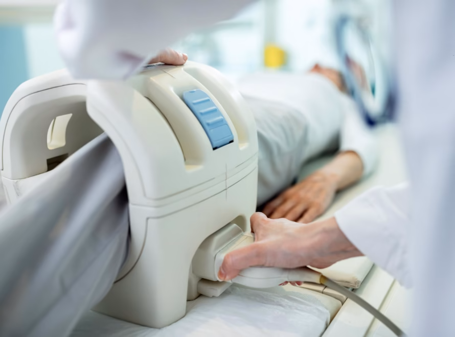 Medical staff positioning patient for musculoskeletal MRI scan