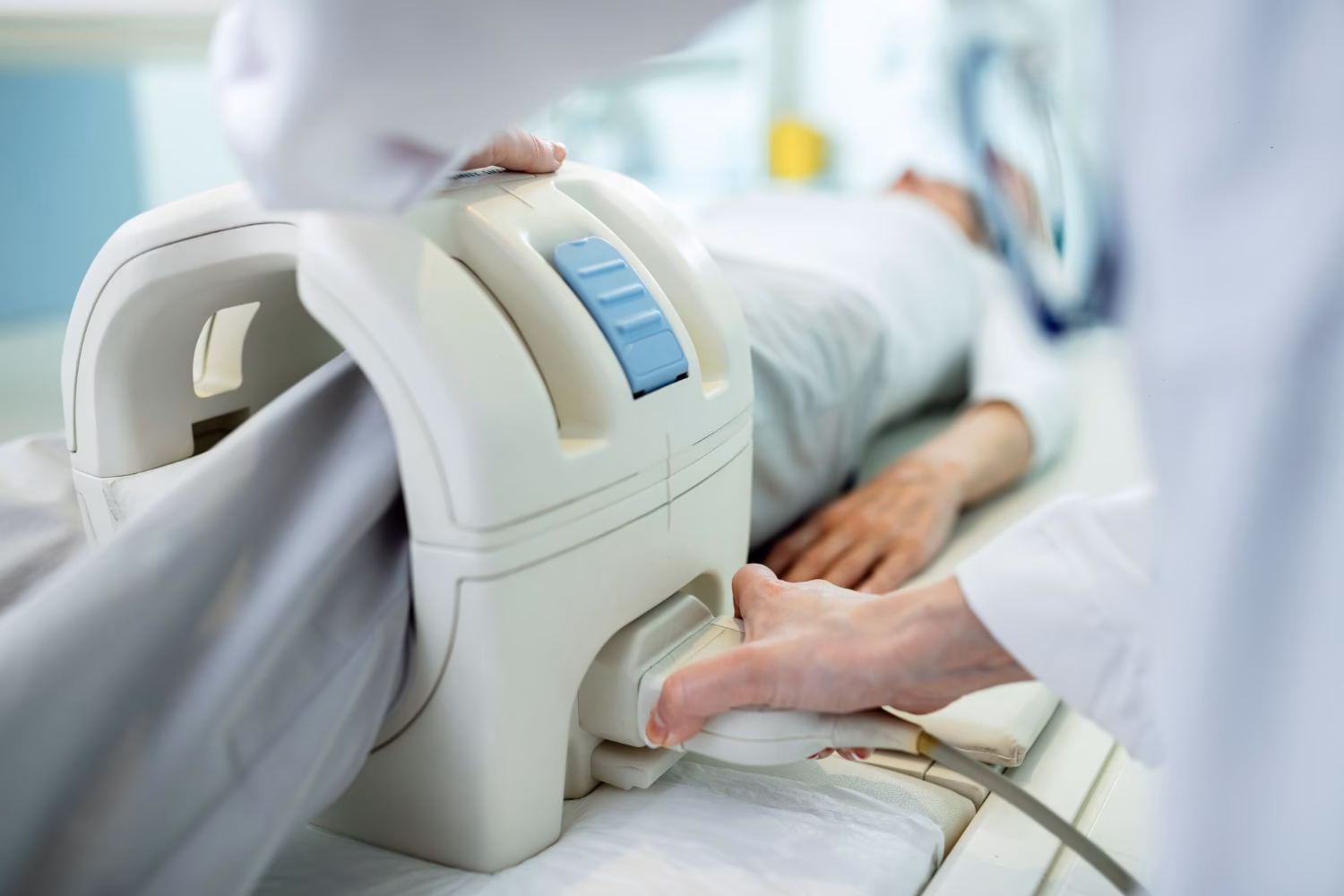 Medical staff positioning patient for musculoskeletal MRI scan
